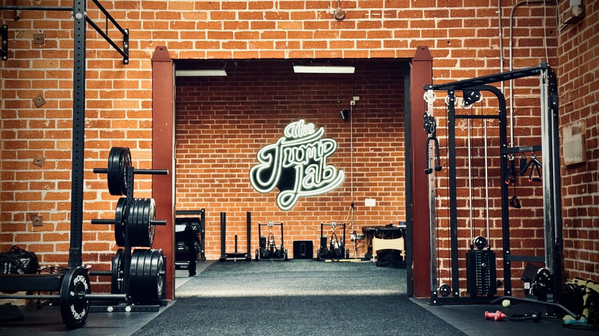 A gym with a brick wall and some equipment