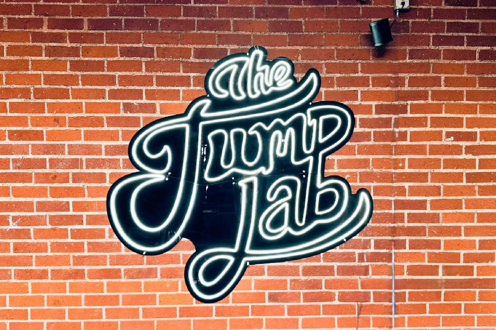 A sign that says the jump lab on a brick wall.