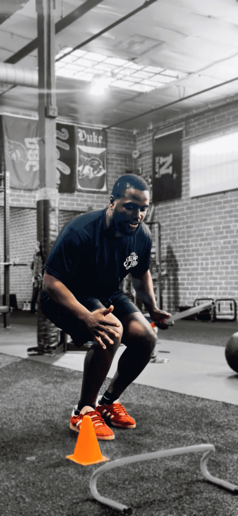 Man doing agility drill with orange cone