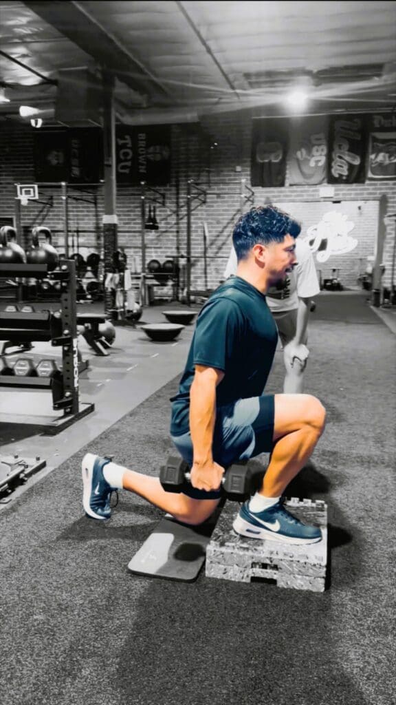 Person performing dumbbell lunge on step