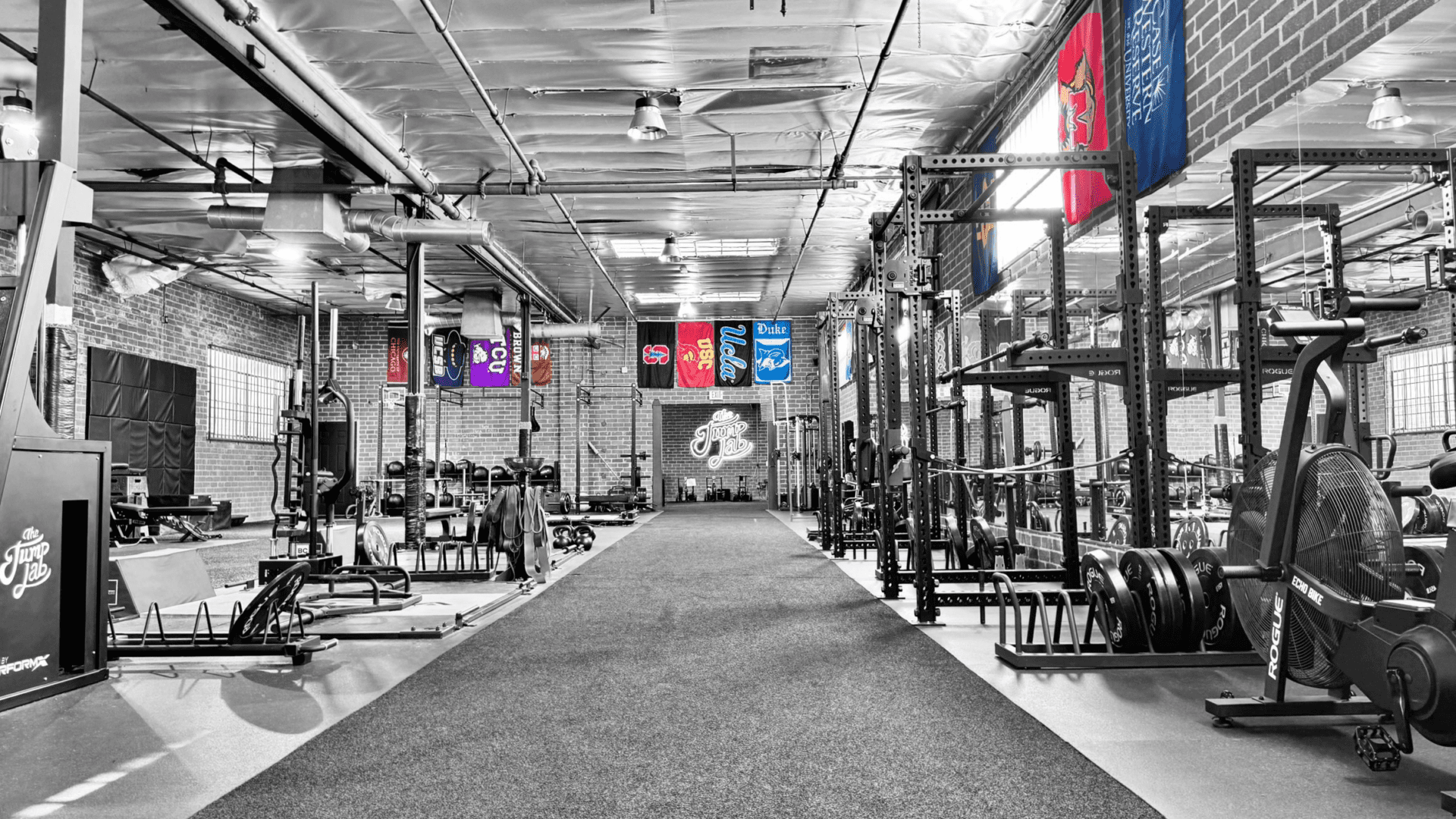 Spacious industrial gym interior with weight racks
